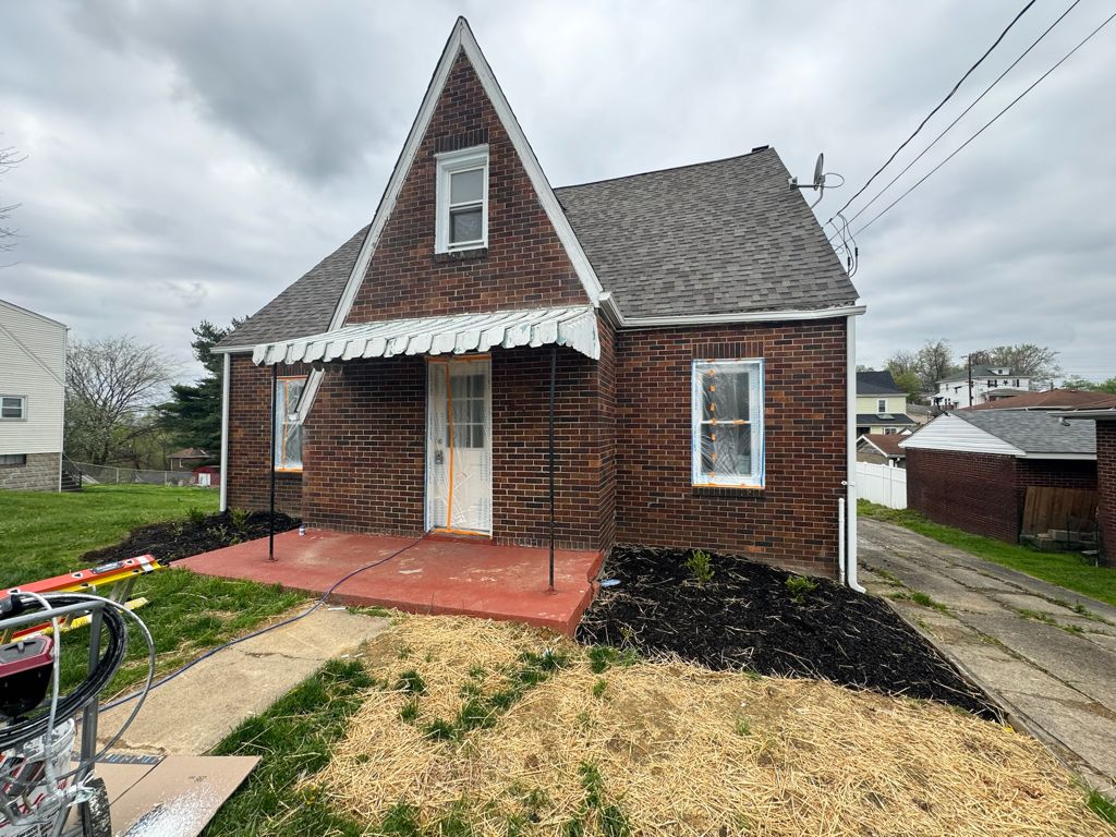 Brick home with freshly painted trim and porch