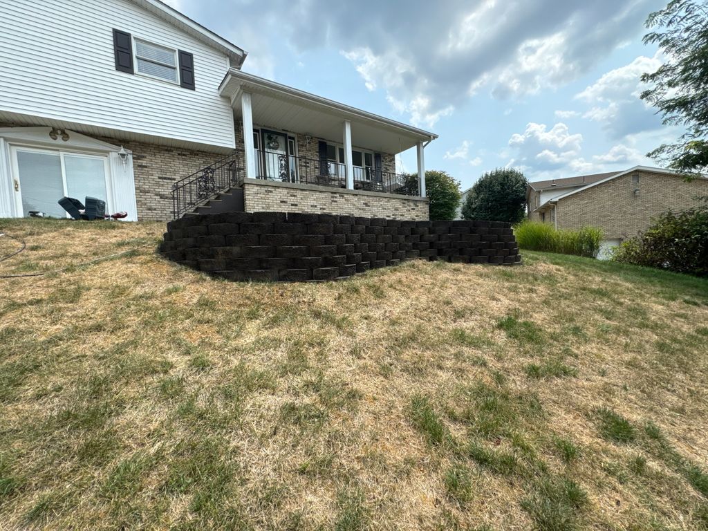 Home exterior with landscaped retaining wall
